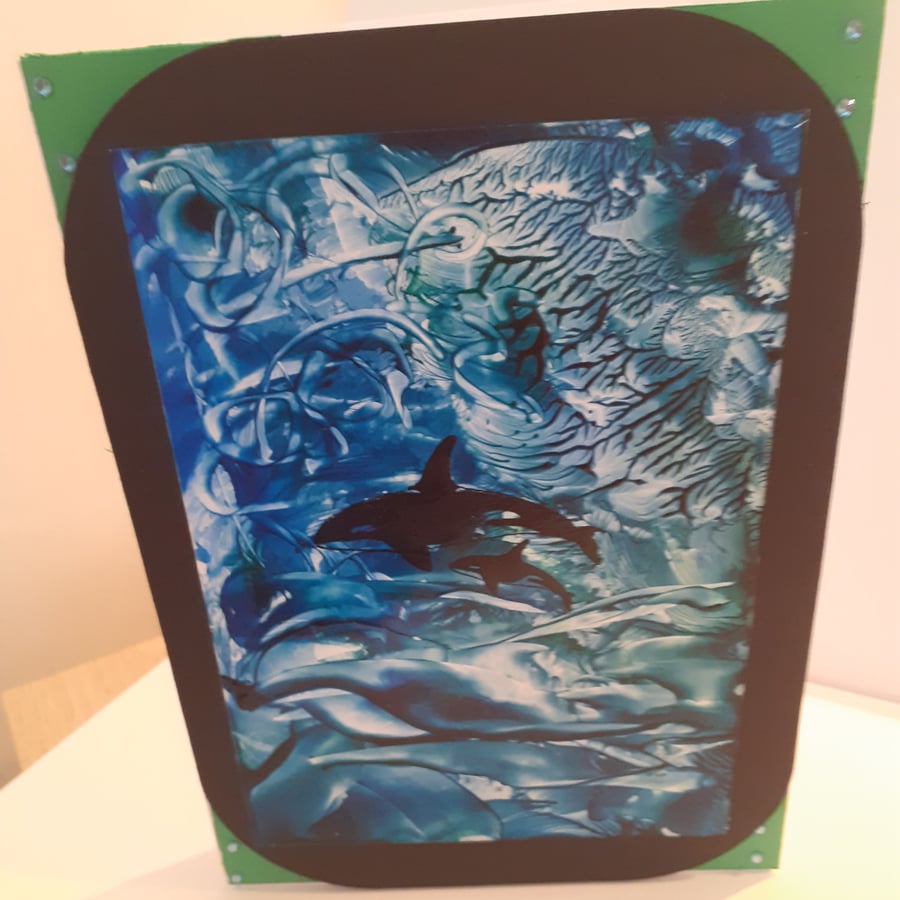 Wax painted dolphins in the ocean greetings card
