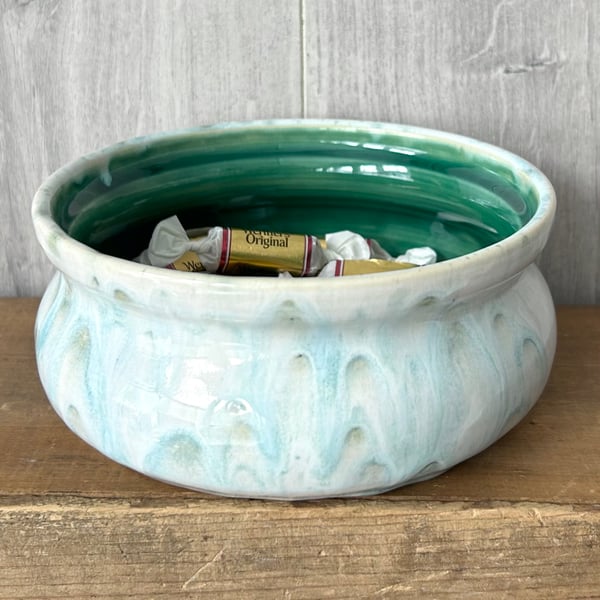 Ceramic hand thrown bowl with white and green drippy glaze