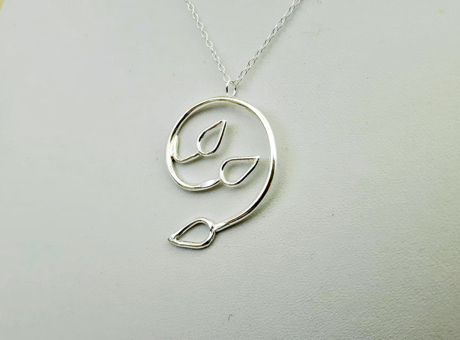 Silver Spiral Pendant with Three Open Leaves. 
