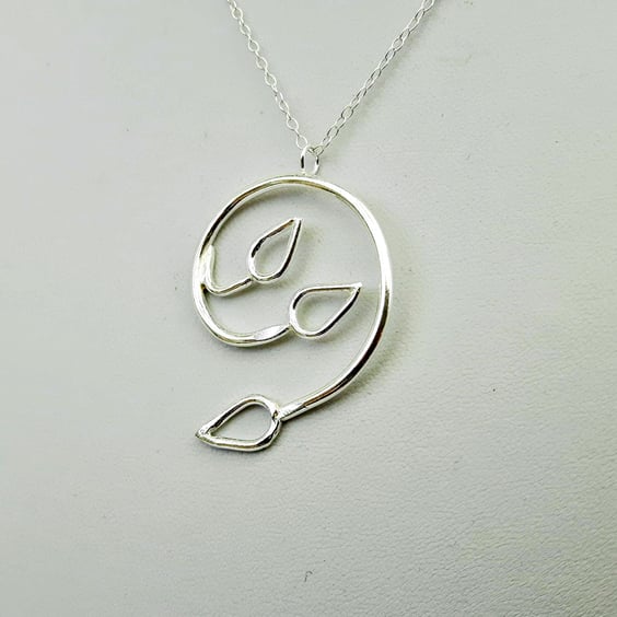 Silver Spiral Pendant with Three Open Leaves. 