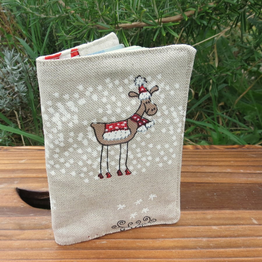 A festive passport sleeve, with a whimsical reindeer design.