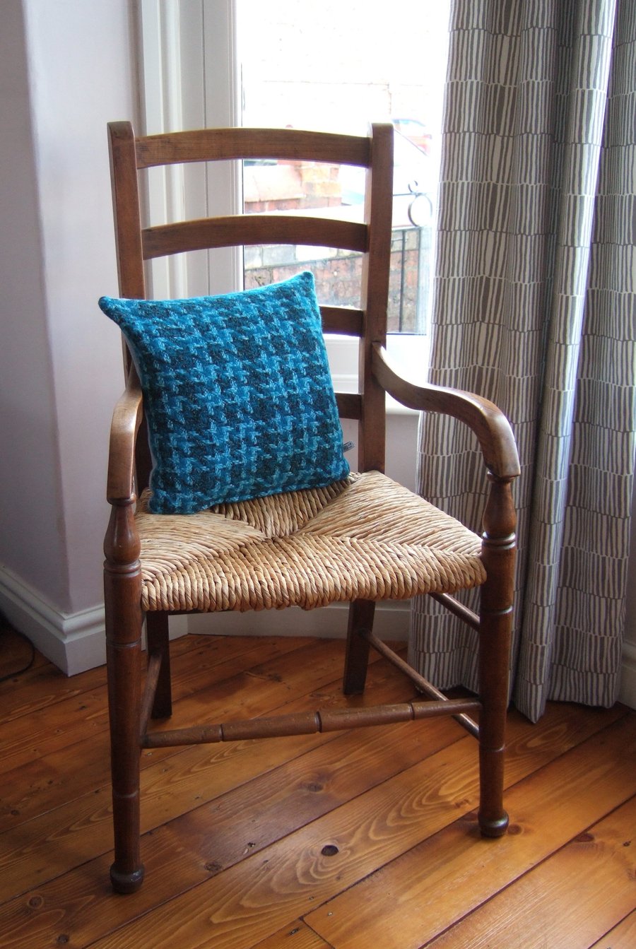 Cushion with woollen chunky weave and feather pad.