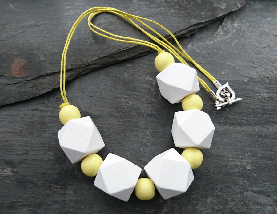 White and yellow geometric wooden necklace with heart shaped toggle clasp