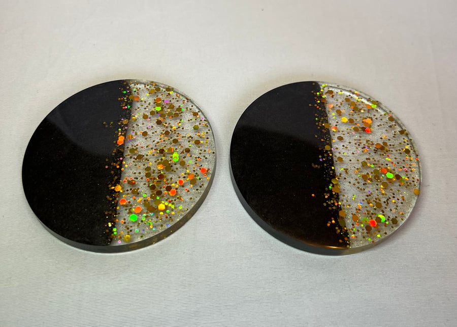 Set of 2 black & gold resin coasters.