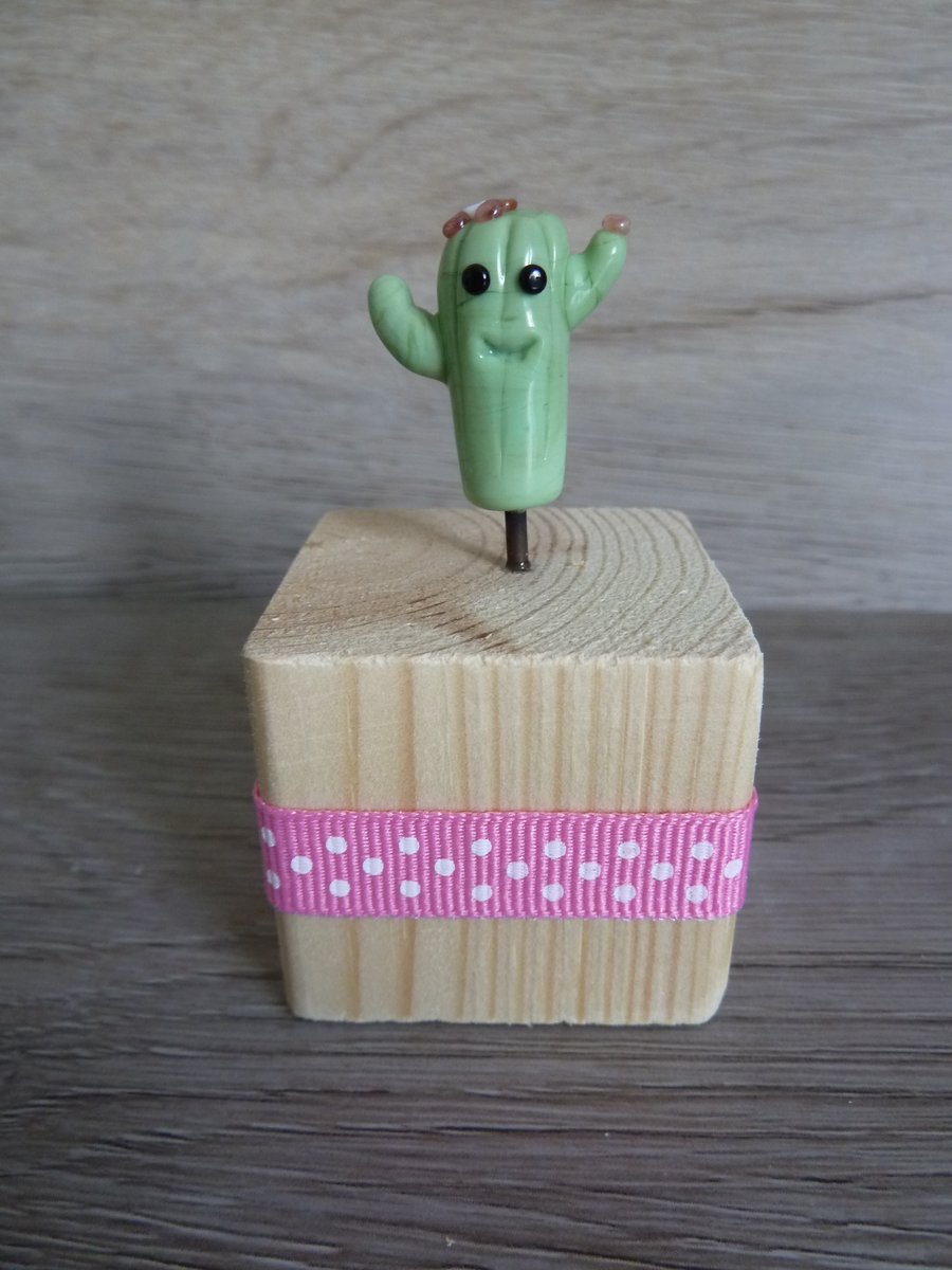 Glass cactus on wooden block