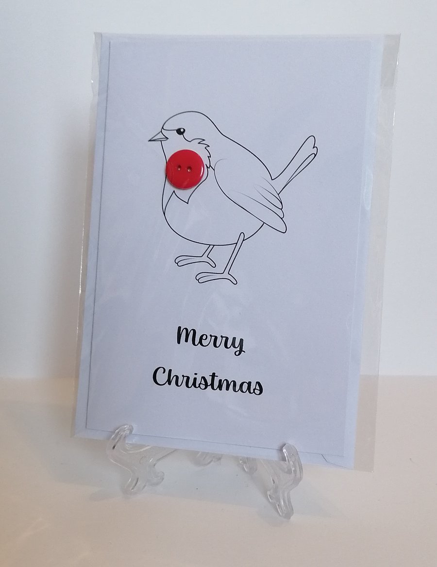 Merry Christmas card with a red button on a robin. 