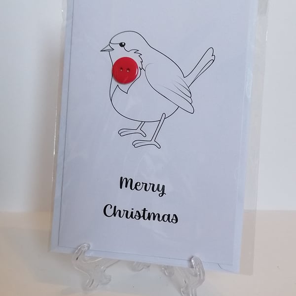 Merry Christmas card with a red button on a robin. 