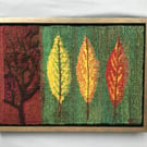 Framed handwoven tapestry weaving, textile art in red, green, orange and yellow