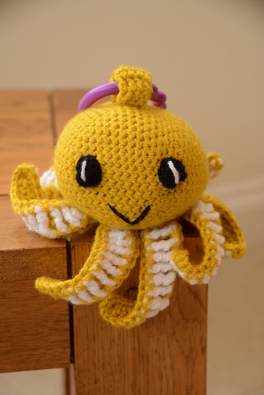 Octopus Soft Toy with teething ring and internal rattle - mustard 
