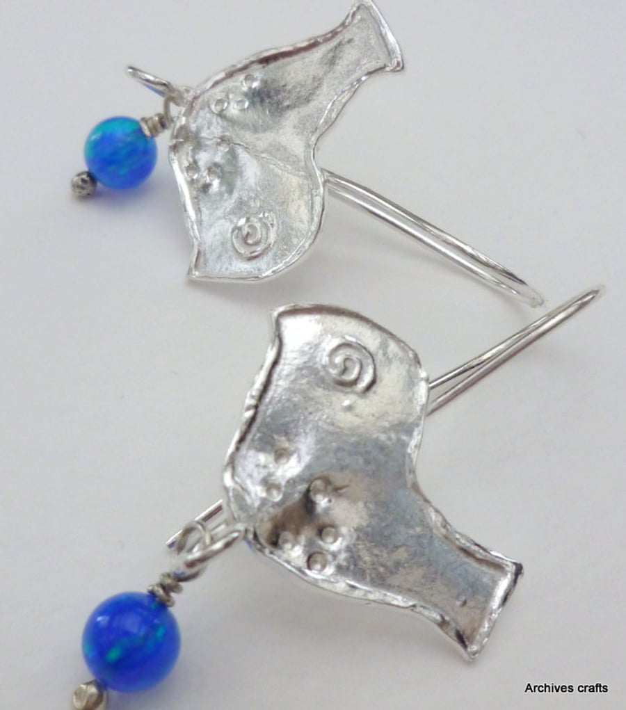 Silver bird earring swith blue opals.