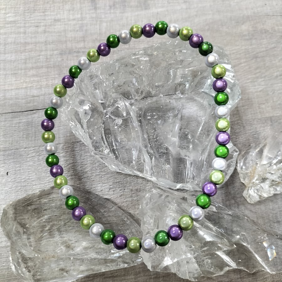 AL145B  Purple, greens and silver miracle bead elasticated anklet , 10.5"