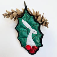 Upcycled embroidered holly leaf and berries hare home decoration. 