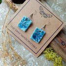 Denim blue flower print ceramic earrings on surgical steel hooks