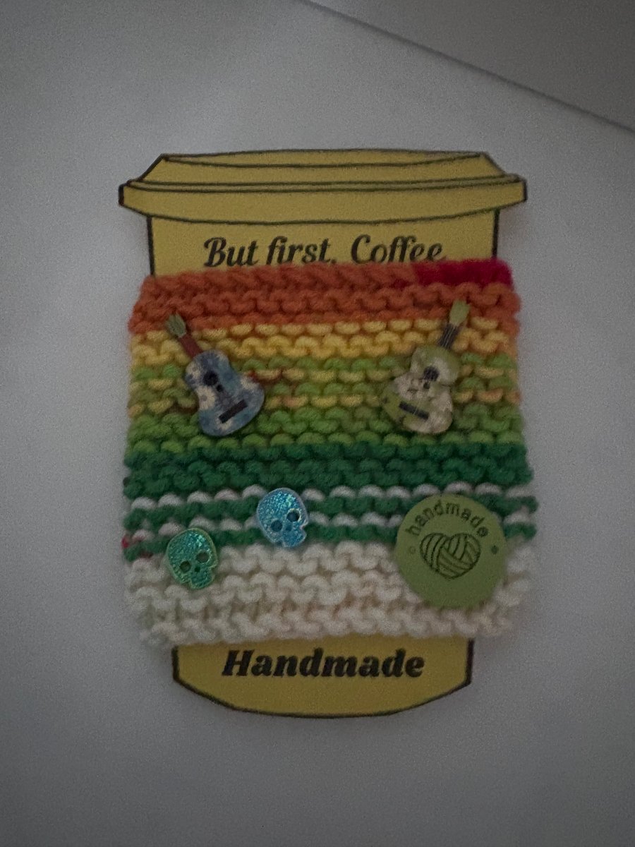 Guitar and skills knitted cup cosy. 