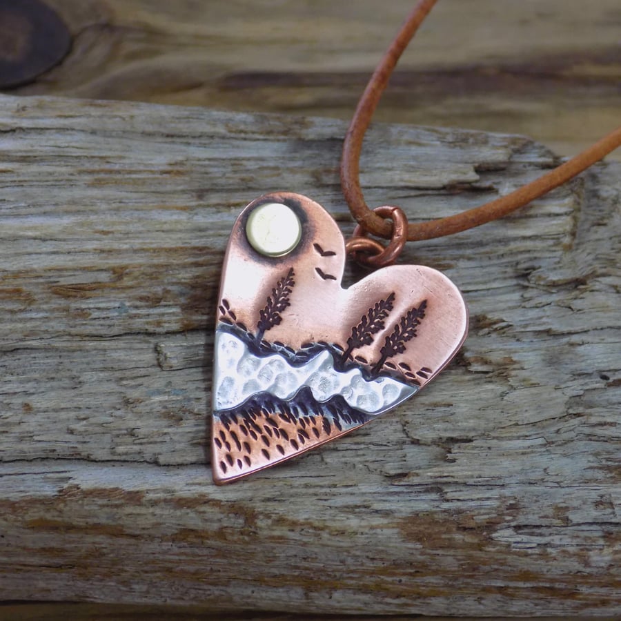 Copper, silver and brass mixed metal heart scene pendant 