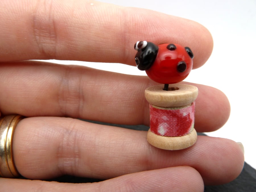 small glass bobbin, ladybird