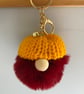Burgundy Faux Fur Pom-Pom Gonk Keyring with Yellow Hand Knitted Hat - Image 1