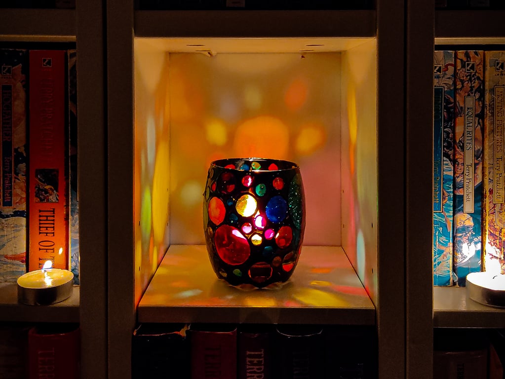 Stained glass effect painted tea light holder with multi-coloured circles 