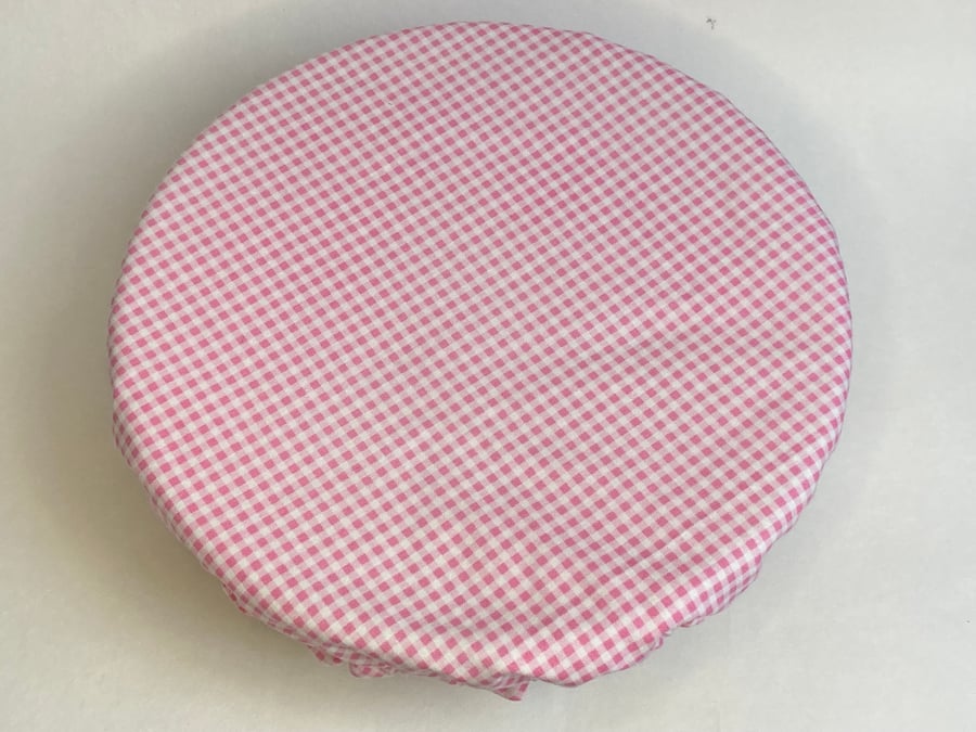 One extra large reusable bowl cover to fit a mixing bowl. Pink check