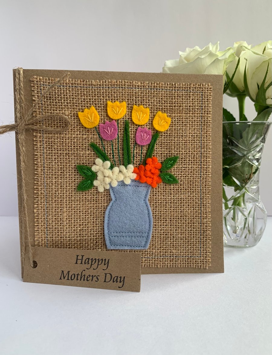 Handmade Mother’s Day. Bright flowers in a pale blue vase. Keepsake card.