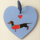 Dinky the Dachshund on a wooden heart shape