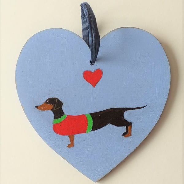 Dinky the Dachshund on a wooden heart shape