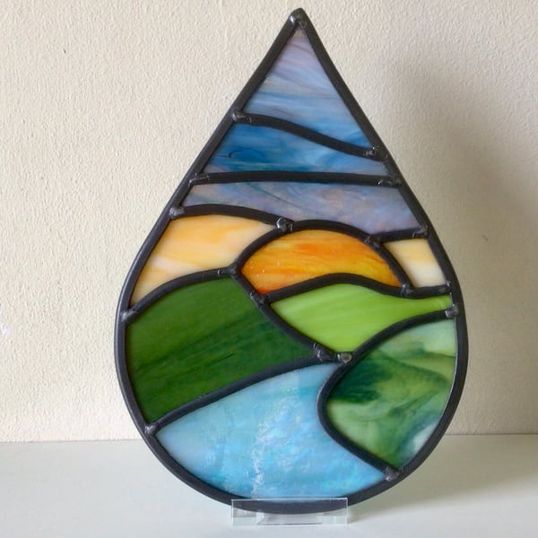 Leaded stained glass river landscape teardrop panel, blue sky