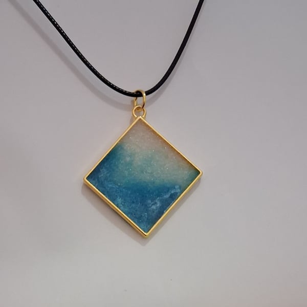 Handmade resin blue and white shimmer pendant on  black waxed cord
