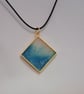 Handmade resin blue and white shimmer pendant on  black waxed cord