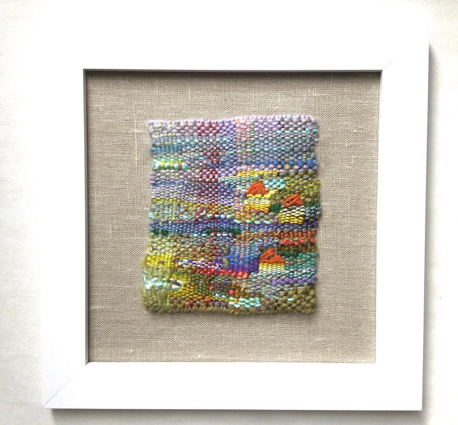 Framed handwoven tapestry weaving, textiles in green, lilac, orange and yellow