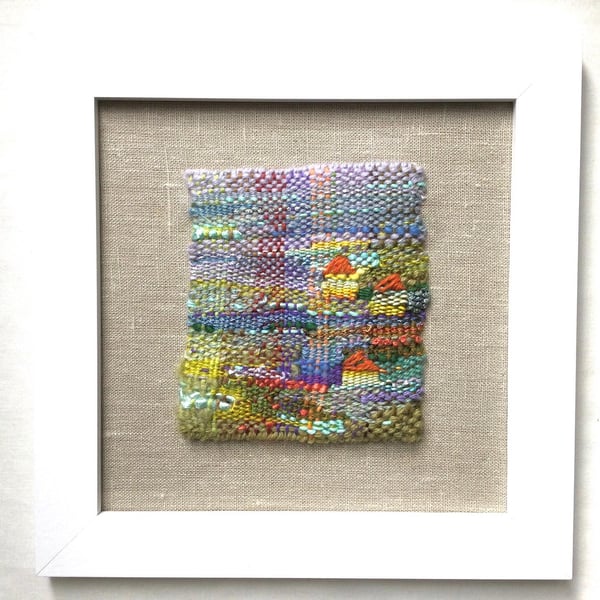 Framed handwoven tapestry weaving, textiles in green, lilac, orange and yellow