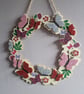Wooden wreath with flowers and butterflies. 