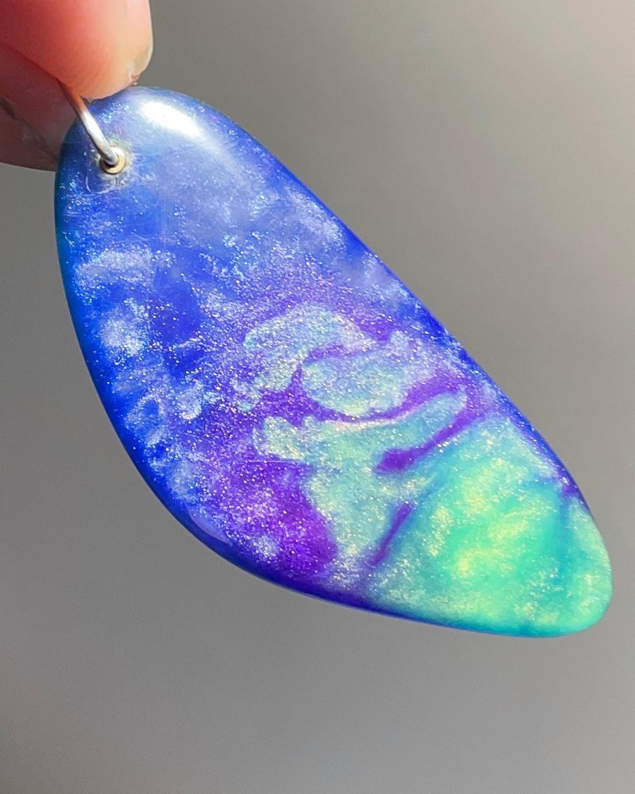 Stunning peacock coloured resin pendant. Handcarved one of a kind piece