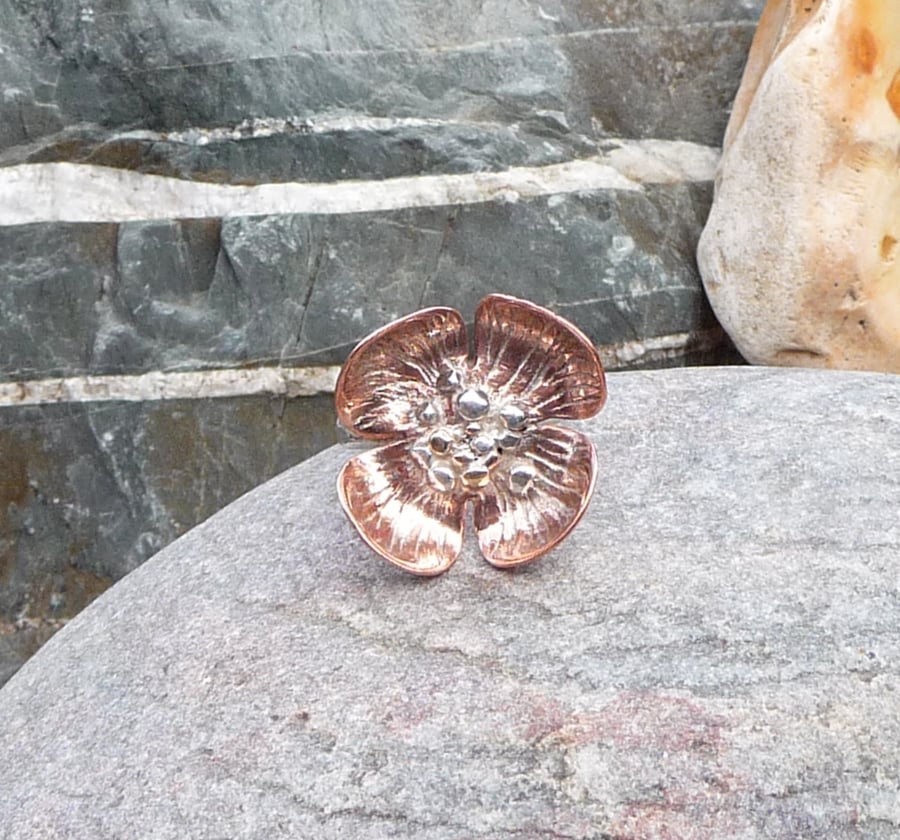 Large copper flower ring with gold granulations and silver band.