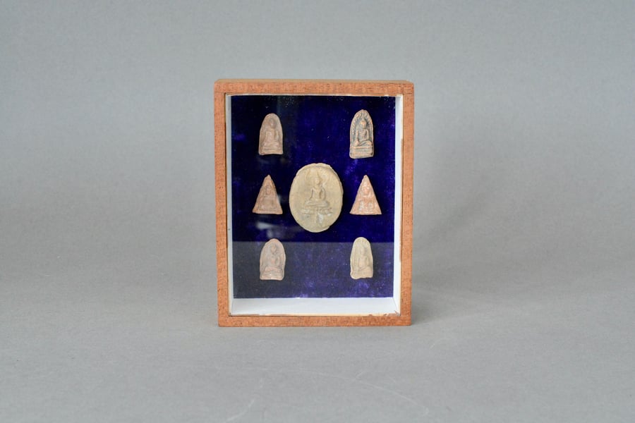 Antique pottery Buddha amulets mounted in a box frame
