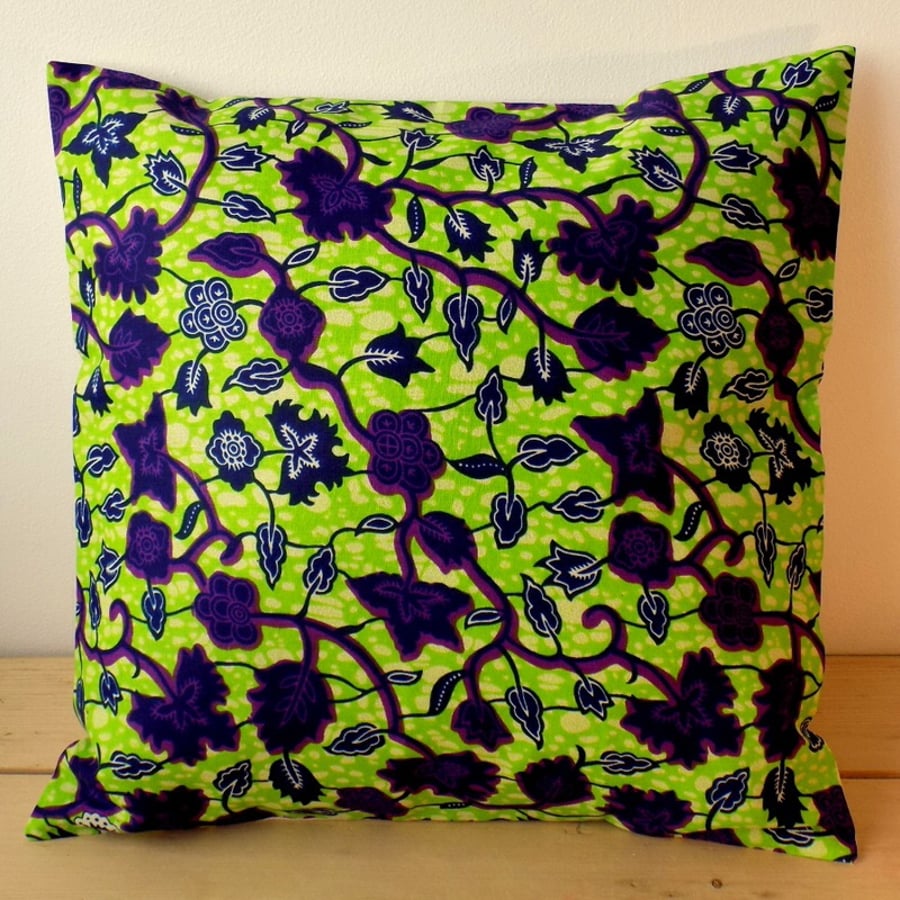 Cushion cover. African wax print in purple and indigo on lime green
