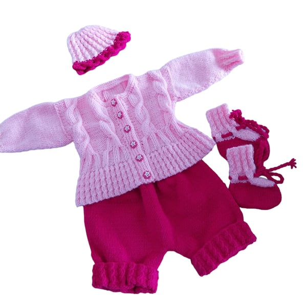Pink hand knitted baby cardigan, shorts, hat and booties