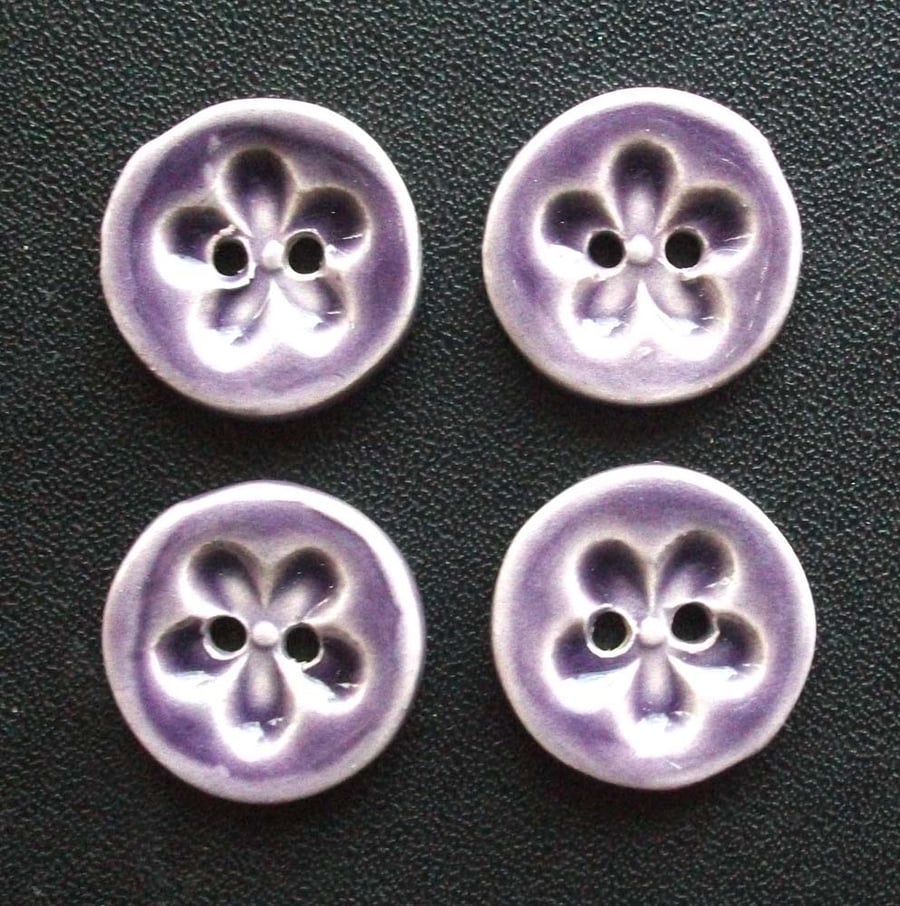 Set of four little handmade ceramic buttons purple flowers
