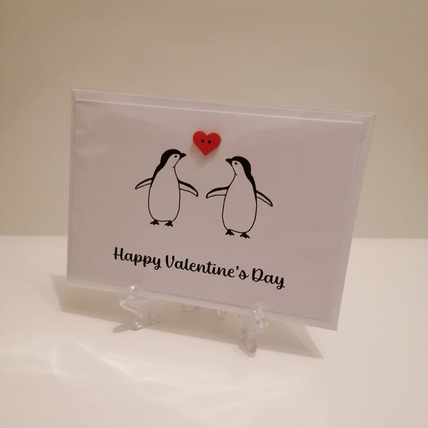 Happy Valentine's Day penguins with a red heart button greetings card 