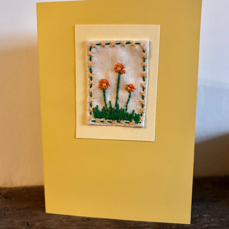 Hand embroidered yellow card with orange gerbera flowers