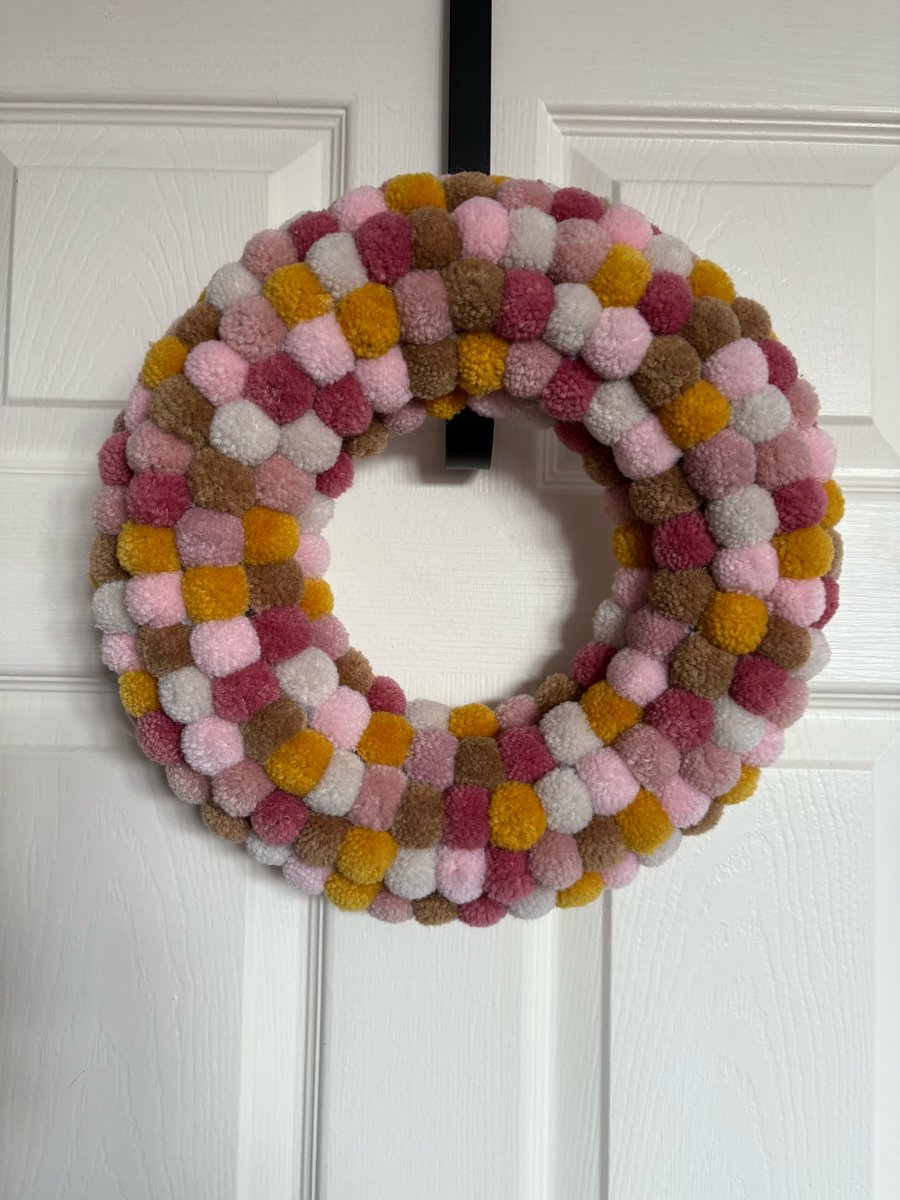 Pom Pom decorated wreath. 