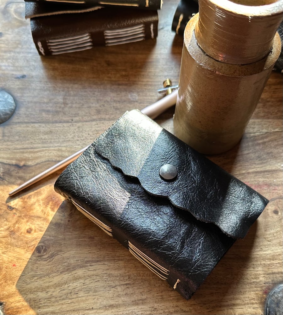 Up cycled soft leather, handmade, ivory waxed thread long stitch pocket journal.