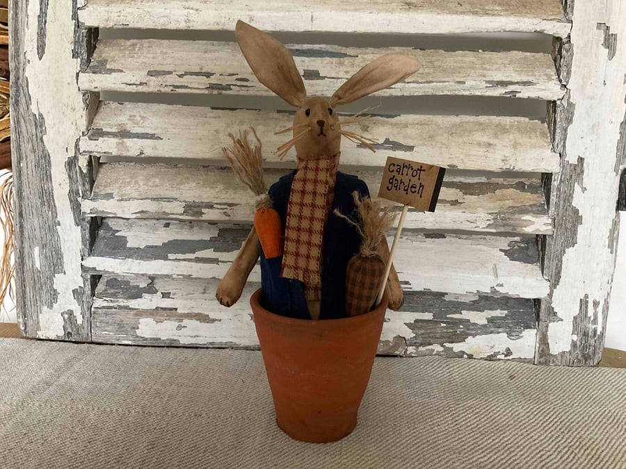 A charming primitive handmade rabbit in a rustic Tom Tom pot