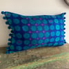 Purple and teal vintage fabric cushion cover with pompoms
