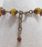 Rustic heart bracelet in red and dark yellow tones - Image 9
