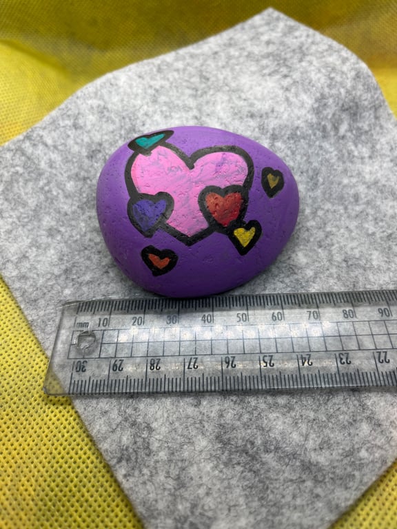 Hand painted pebble with coloured hearts