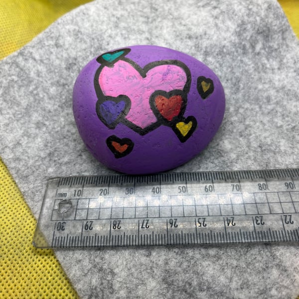 Hand painted pebble with coloured hearts
