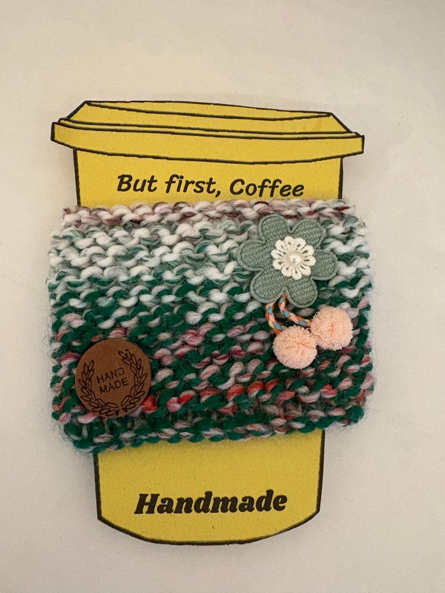 Flower Pom Pom knitted cup cosy. 