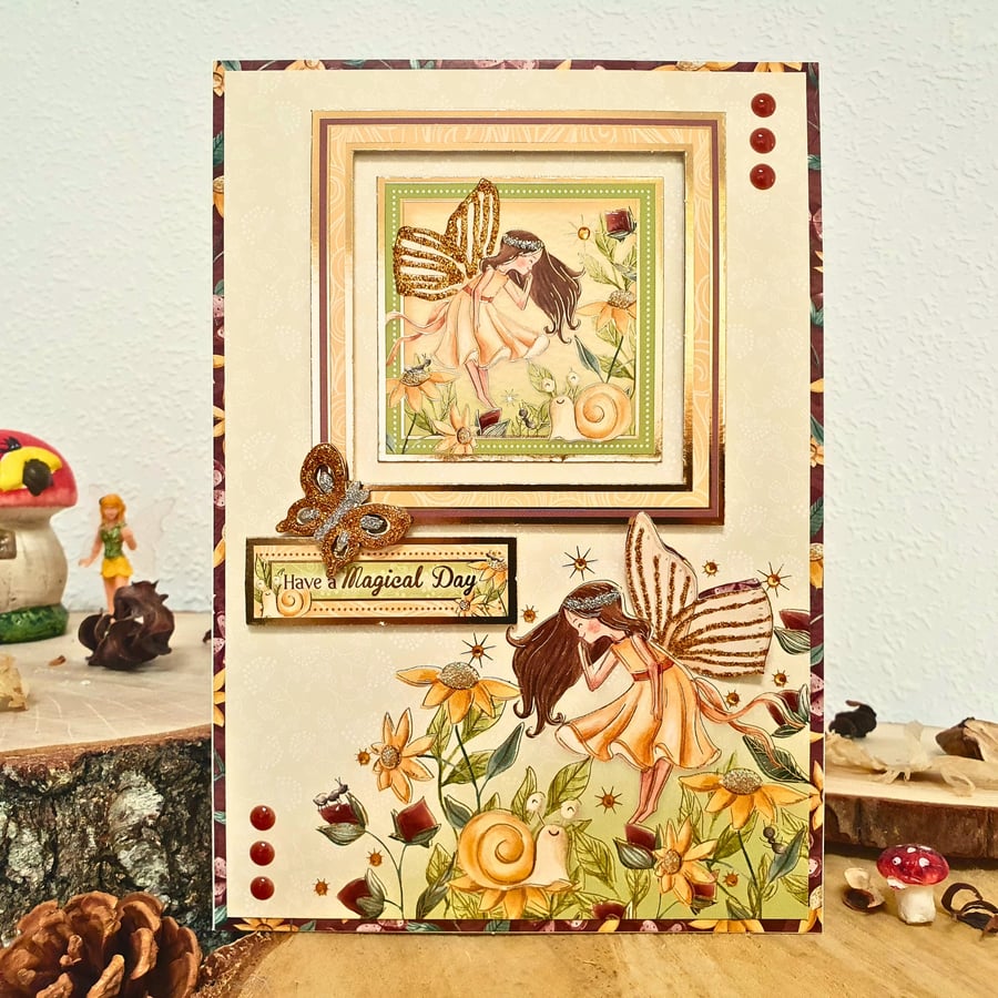 Birthday Card With A Fairy Hovering Over Wild Flowers "Have A Magical Day"