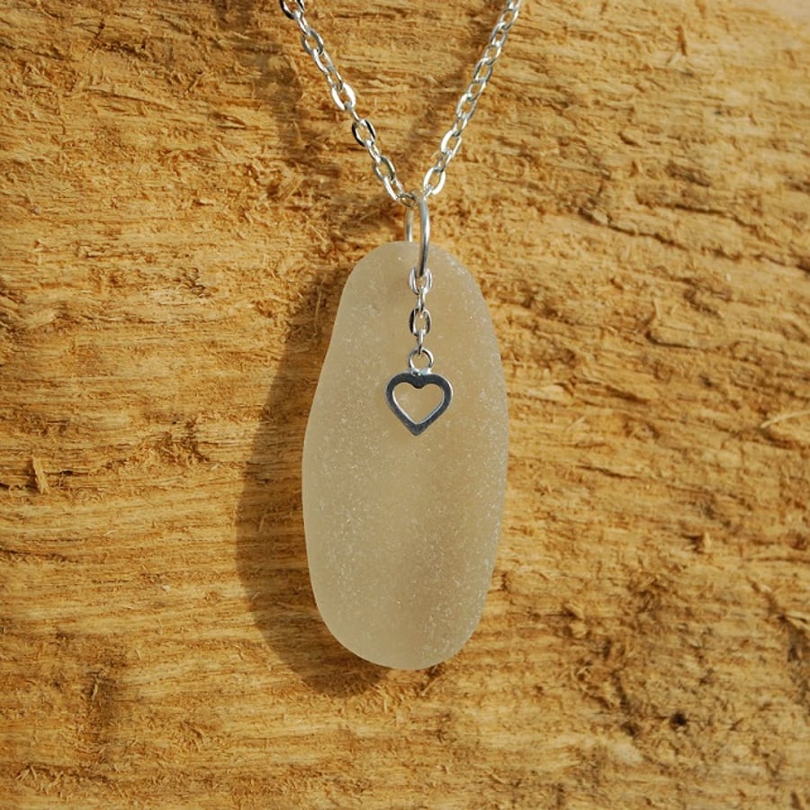 White sea glass pendant with sterling silver heart charm